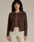 Woman wearing a brown goat suede trucker jacket with snaps buttons