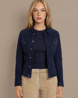 Woman wearing a navy goat suede trucker jacket
