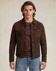 Western cowboy man wearing a dark brown goat suede trucker jean jacket