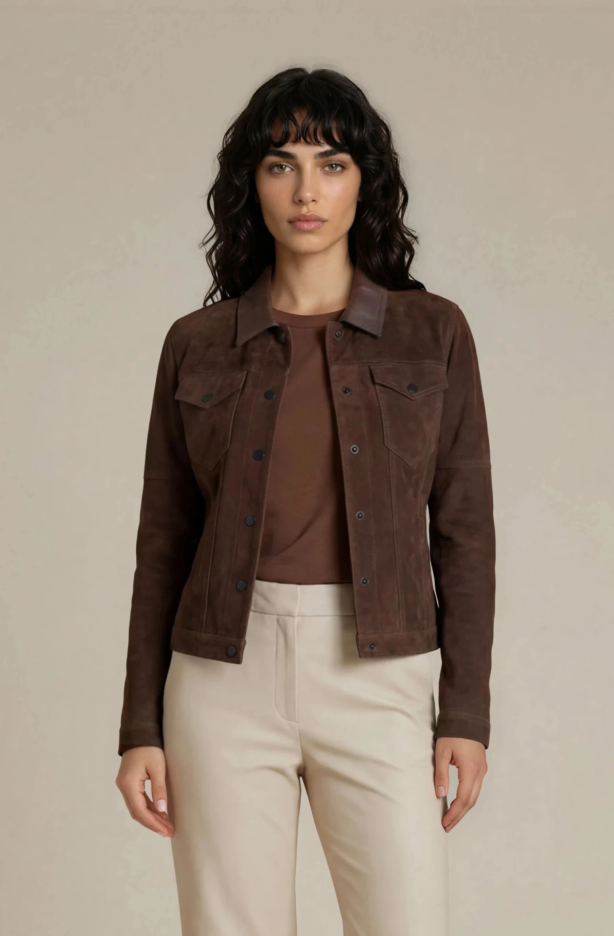 Woman wearing a brown goat suede trucker jacket with snaps buttons
